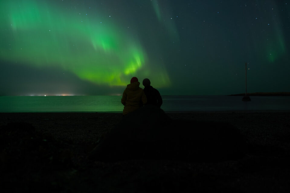 elopement couple fascinated by aurora in Iceland