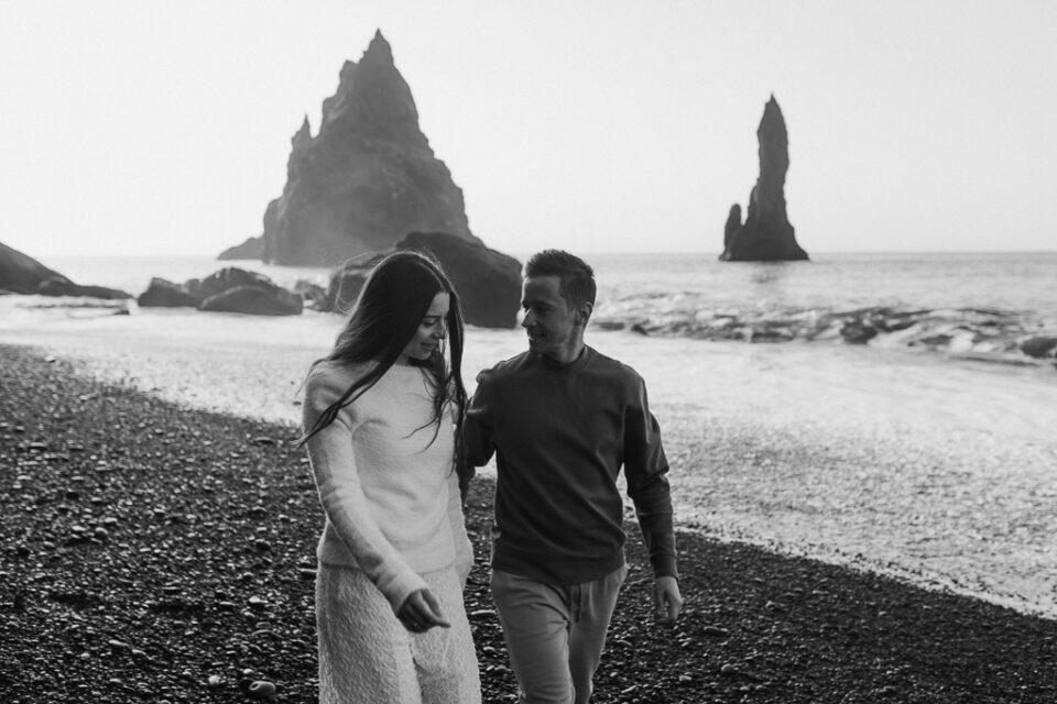 Breathtaking elopement couple captured amidst the otherworldly beauty of Reynisfjara at the break of dawn, a symbol of their enduring love