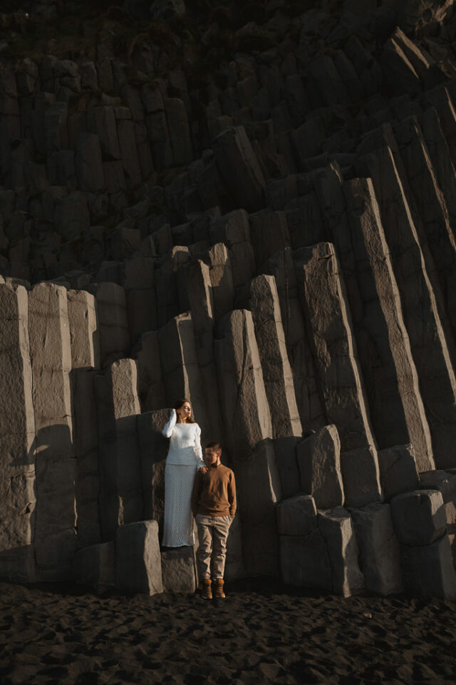 Intimate wedding portrait captured amidst the rugged beauty of Reynisfjara's ancient basalt columns