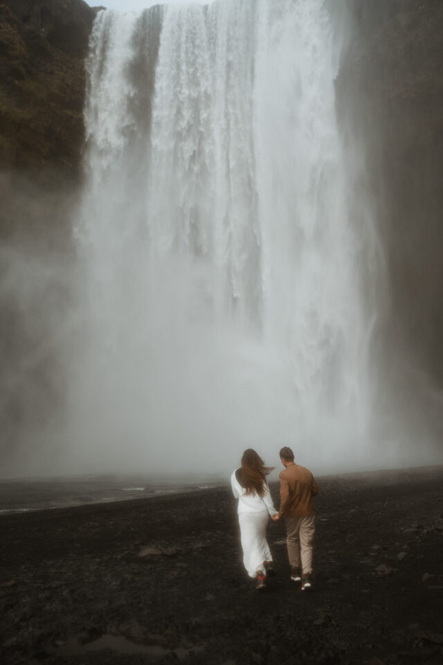 Romantic elopement photo session by Skogafoss, capturing the magic of Iceland's natural wonders