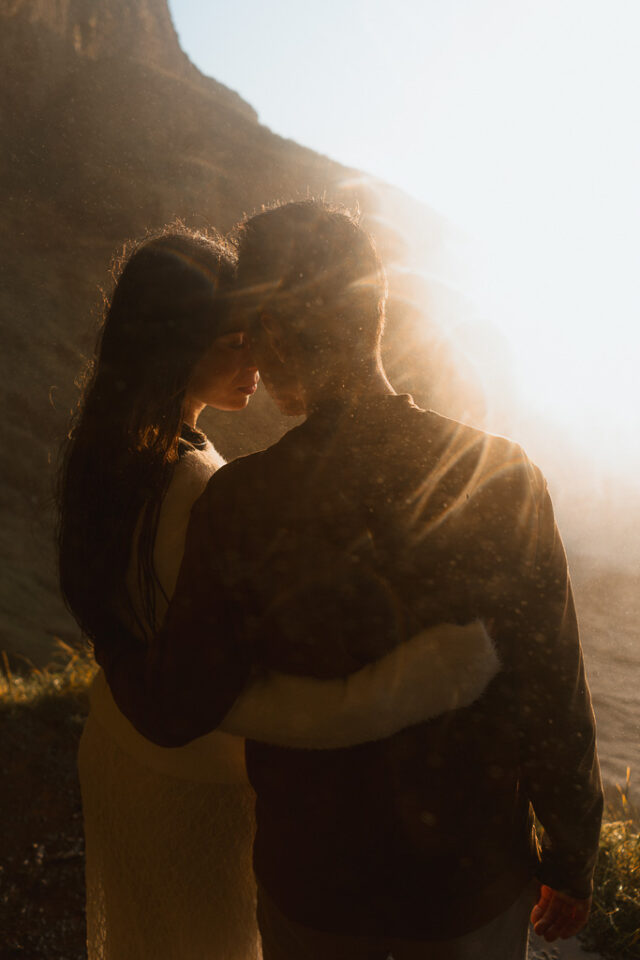 Enchanting moment as the couple embraces each other tenderly against the backdrop of Seljalandsfoss, illuminated by ethereal light