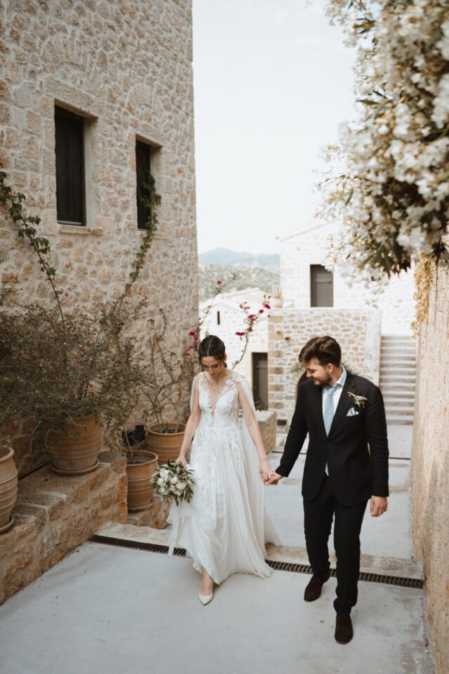 Couple walking through historic Greek stone alley