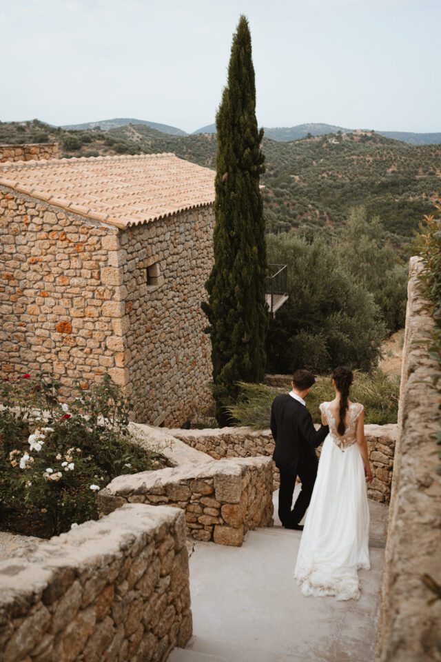 Bride and groom portrait on terrace overlooking hills
