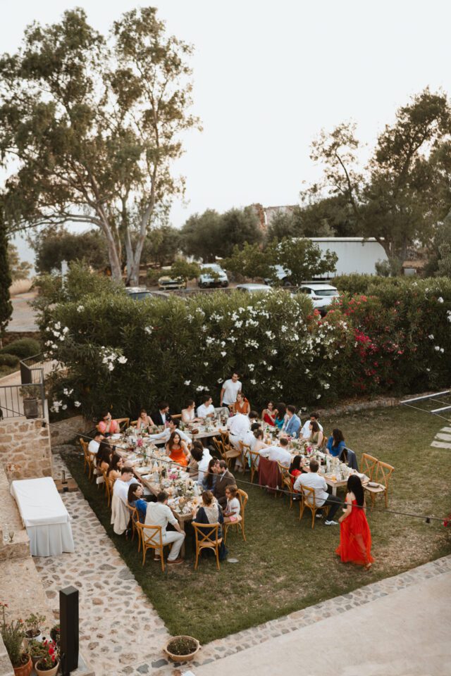 Outdoor wedding dinner with guests in Greece