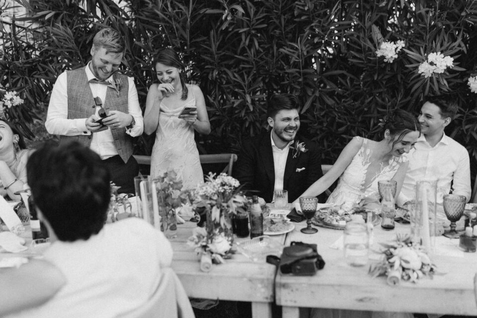 Joyful wedding toast at outdoor reception in Greece