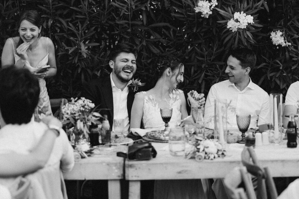 Groom celebrating with friends during wedding dinner